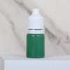 A small glass bottle of green water marbling paint for kids with a white cap