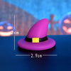 A purple witch hat with a yellow band and a small pumpkin decoration, shown against a blue background.