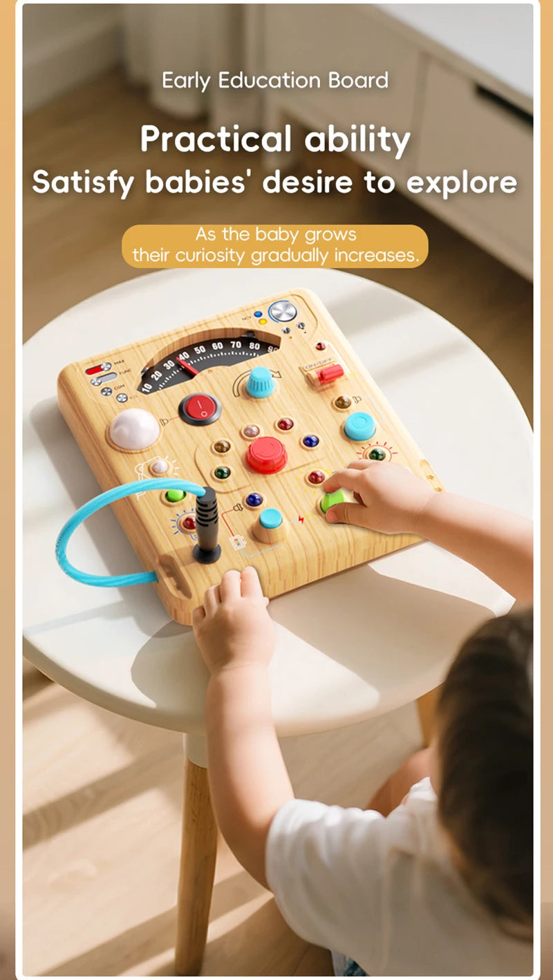 A child is interacting with a wooden early education board featuring various lights and switches for sensory exploration.