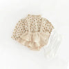 A vintage floral baby girl outfit set featuring a light-colored blouse and matching ruffled romper.