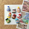 A set of eight kawaii jam jar fridge magnets featuring various fruit and food themes.