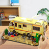 A building block set depicting a yellow RV camper bus with various outdoor elements and accessories.