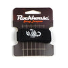 A black guitar string dampener is shown packaged on a brown cardboard backing.