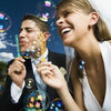 A smiling woman and man holding colorful bubble wands with 5-hole designs against a blue sky background.
