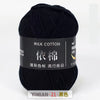 A skein of black milk cotton yarn for knitting and crochet labeled with Chinese text.