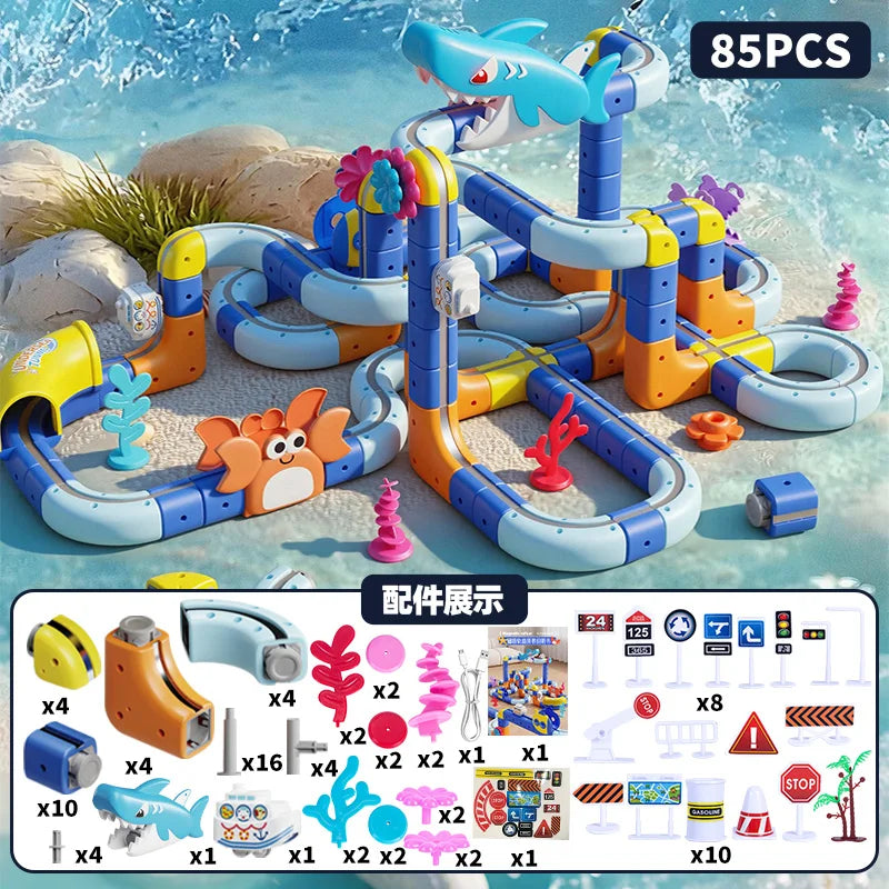 A colorful magnetic anti-gravity train building set with an electric track is shown on a beach background.