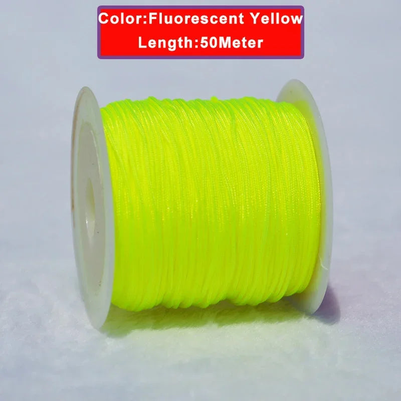 A spool of fluorescent yellow nylon knotting cord, 50 meters long, for jewelry making.