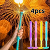 A hand holds a blue water spray toy, with four colorful plastic spray toys displayed below against a background of fireworks.