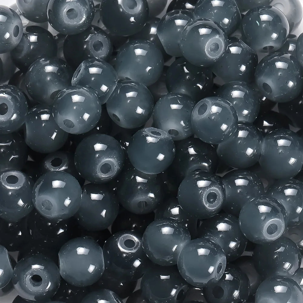 A close-up view of dark gray glass round beads for DIY jewelry making