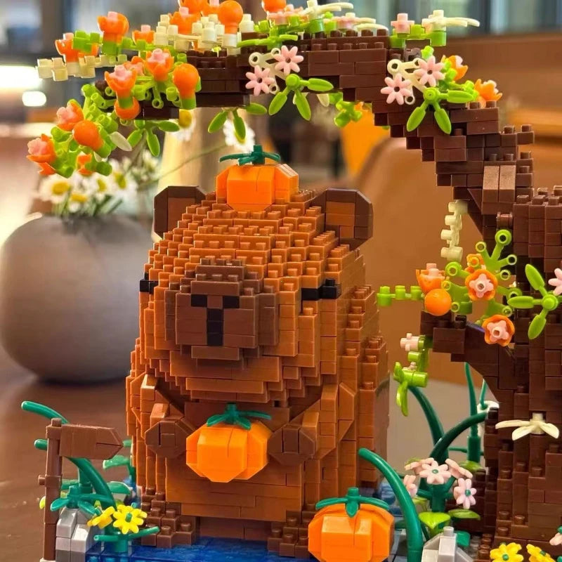 A detailed building block scene featuring a bear and a bridge structure with orange and pink flowers.