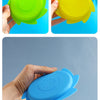 A hand holds a blue silicone splash flying ring toy for water play.