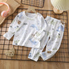 White cotton pajama set for kids featuring a light blue watercolor pattern of marine life and foliage