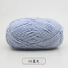 A ball of light blue pre-dyed milk cotton yarn used for knitting and crochet.