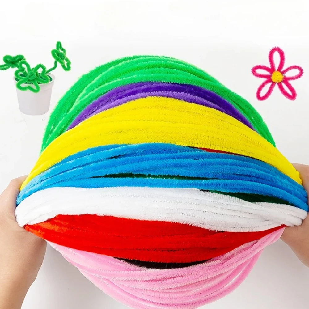 A ball of multicolor chenille stem pipe cleaners, including green, purple, yellow, blue, white, red, and pink.