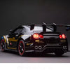 Black Nissan GTR model car with racing details and light effects displayed against a dark background.