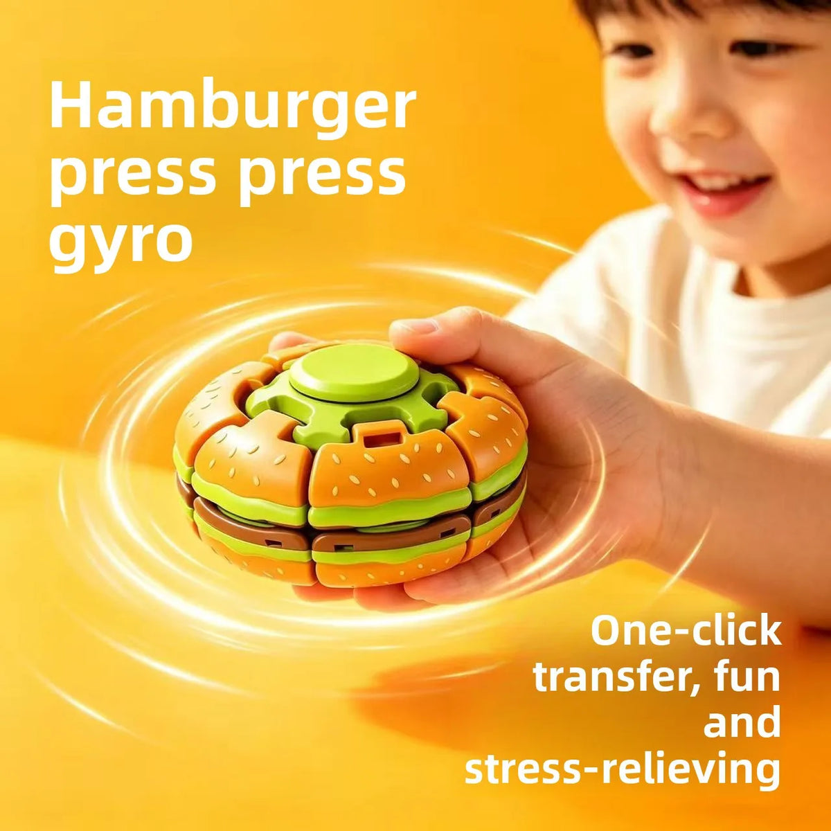 A child holds a green and orange burger-shaped press gyro toy, demonstrating its one-click transfer and stress-relieving feat