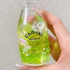 A hand holds a clear bottle of green liquid labeled Chiboki drink cup toy