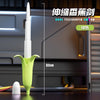 A green telescoping sword toy shaped like a banana, shown against a dark background.