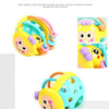 A yellow and teal sensory catch ball rattle toy for babies, featuring soft textures and bright colors.