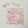 A clear plastic bag filled with numerous colorful kawaii cat paw squishy stress relief fidget toys.