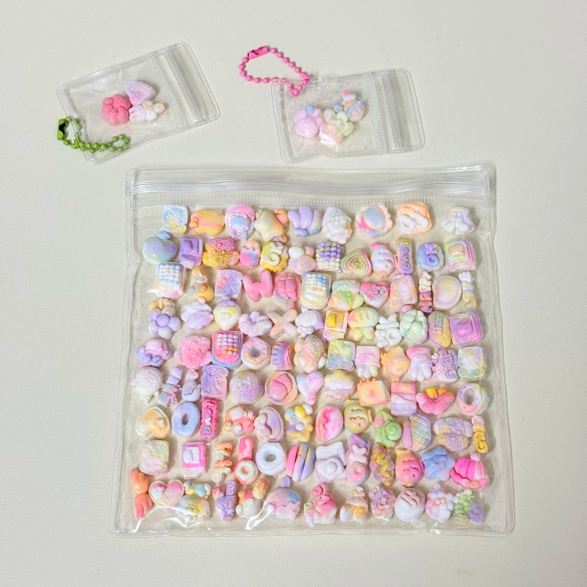 A clear plastic bag filled with numerous colorful kawaii cat paw squishy stress relief fidget toys.