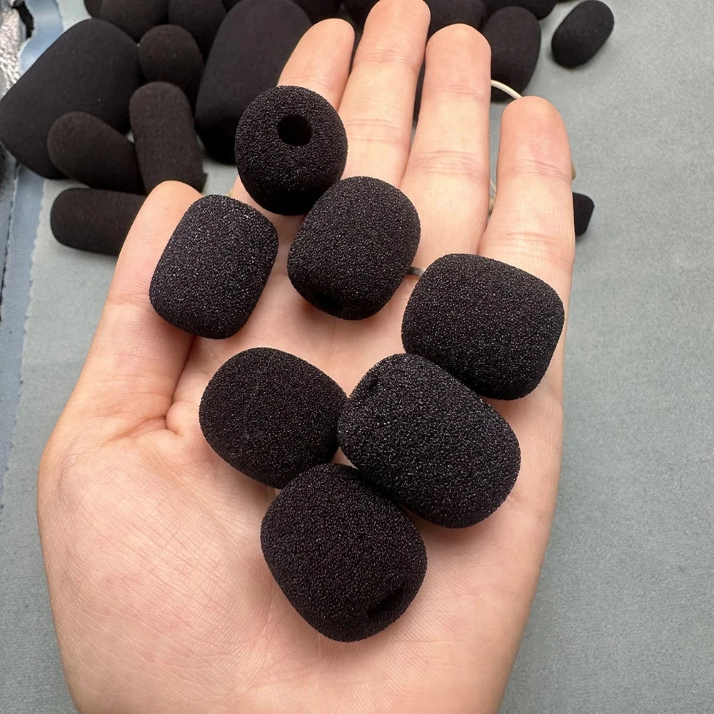 A hand holds a pack of black replacement microphone foam covers for meeting microphones.