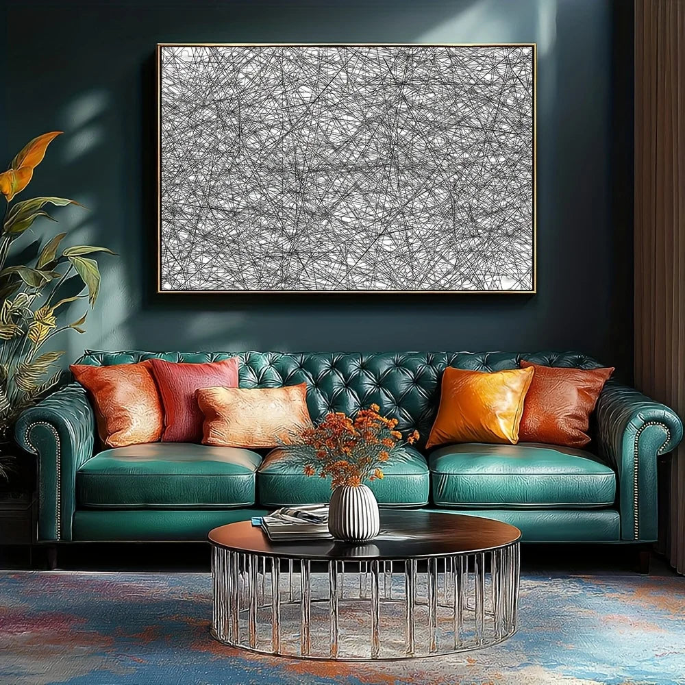 A black and white jigsaw puzzle displayed on a wall above a teal sofa and coffee table.