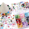 A variety of colorful glass beads in various shapes and sizes are displayed on a white surface.