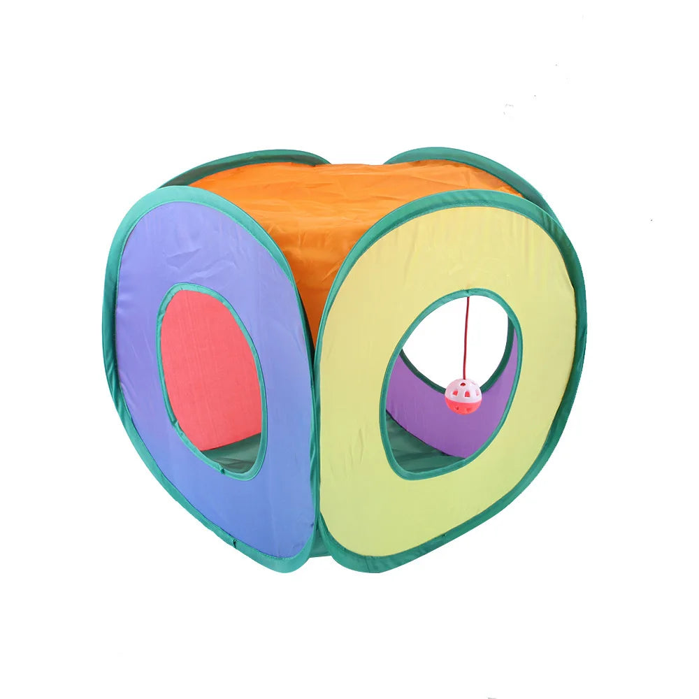 An orange and green foldable S-shaped cat tunnel with a purple interior and a hanging ball toy.