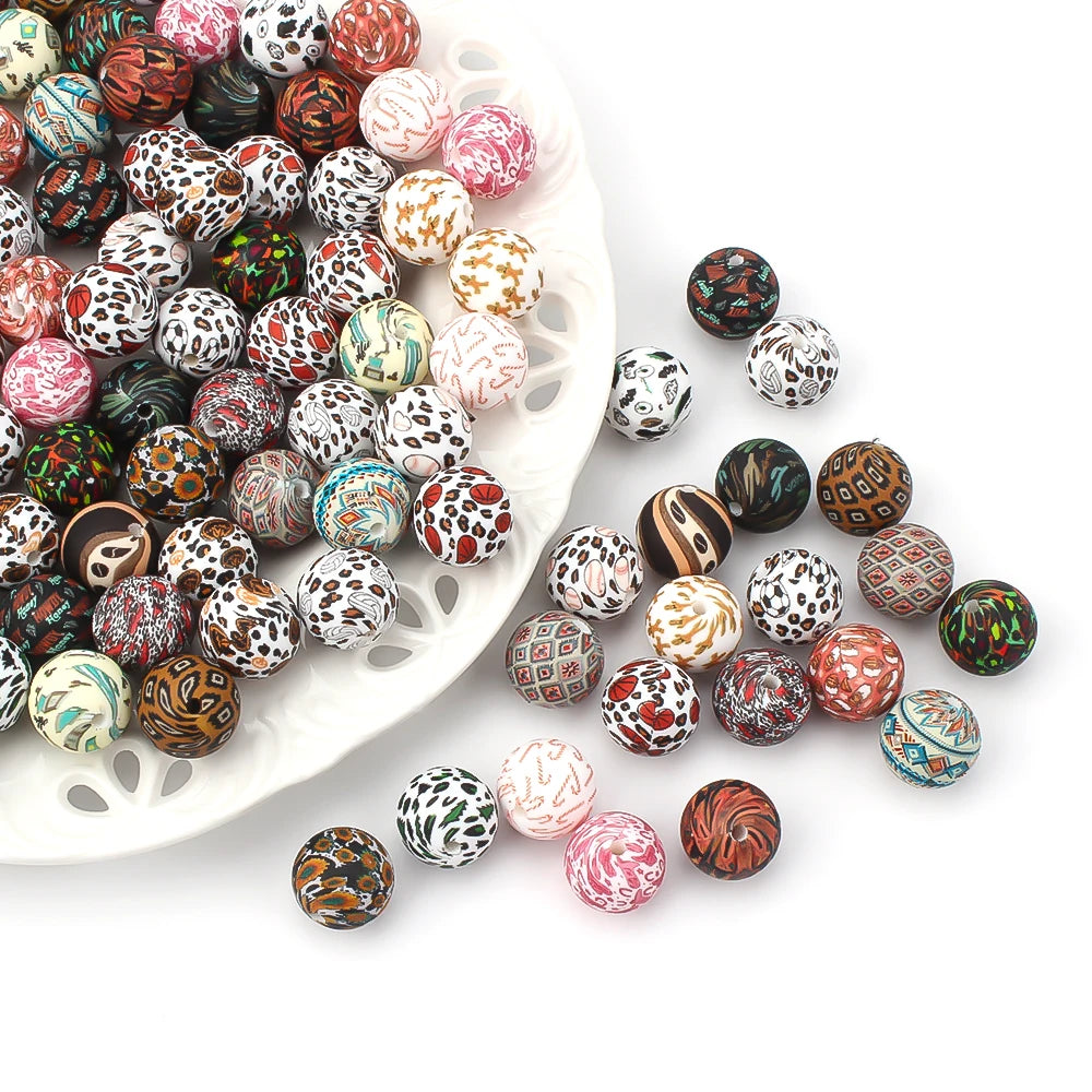 A collection of colorful printed silicone beads in various patterns and colors arranged on a white platter.