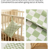 A green and white checkered fabric item, possibly a diaper cover or storage bag, is shown in various contexts.