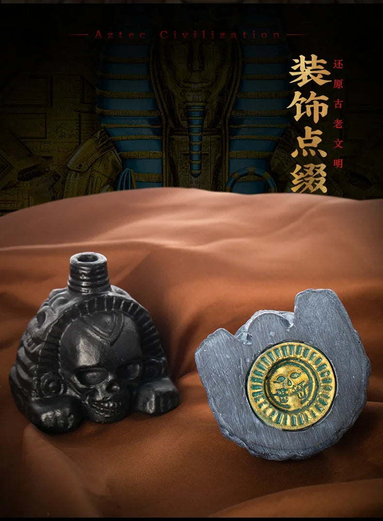 A handcrafted Aztec death whistle with a skull design and gold accents resting on brown fabric.