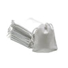 A small, light gray drawstring bag filled with many thin, bundled dice.