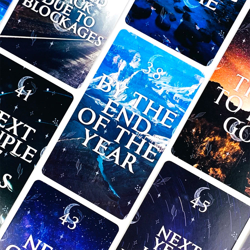 A close-up of a deck of mystical moon oracle cards featuring various celestial and spiritual imagery.