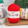 A bright red ball of soft chenille yarn is displayed next to a gray ball and a yellow ball, with labels in Chinese characters