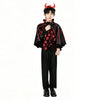 A young person wearing a black vampire bat costume set with a cape and accessories.