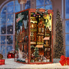 A miniature wooden book nook kit depicting a Christmas street corner with houses and snowy details.