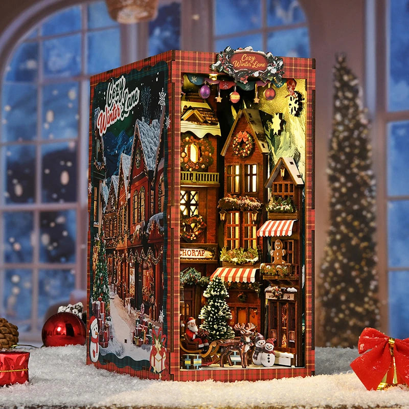 A miniature wooden book nook kit depicting a Christmas street corner with houses and snowy details.