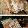 A close-up of vintage decorative paper sheets and ephemera for scrapbooking and journaling on a wooden surface.