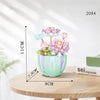 A light green floral bouquet building block set featuring pink and purple flowers displayed on a wooden surface.