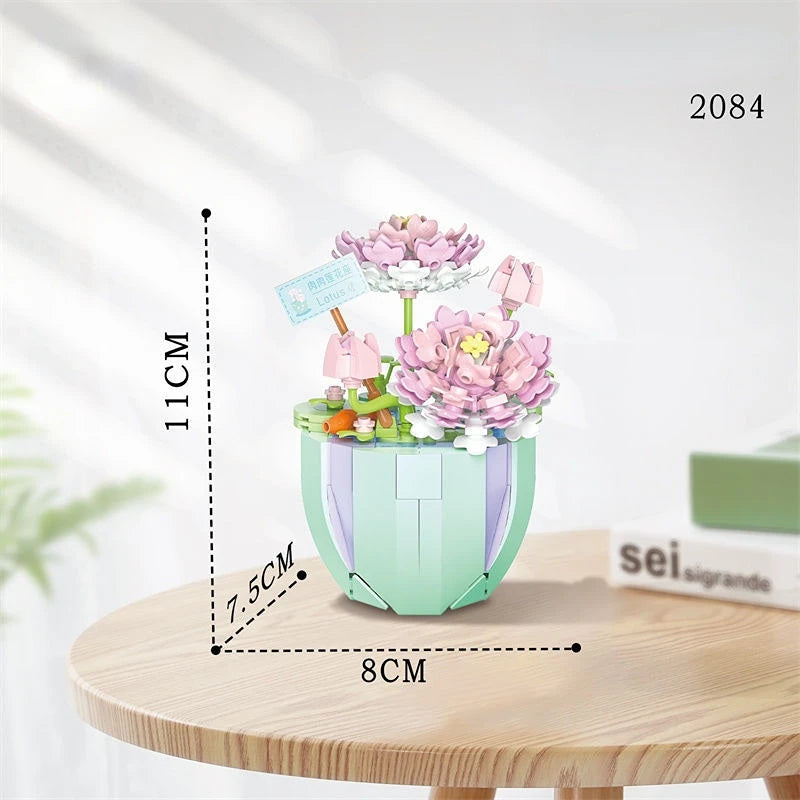 A light green floral bouquet building block set featuring pink and purple flowers displayed on a wooden surface.