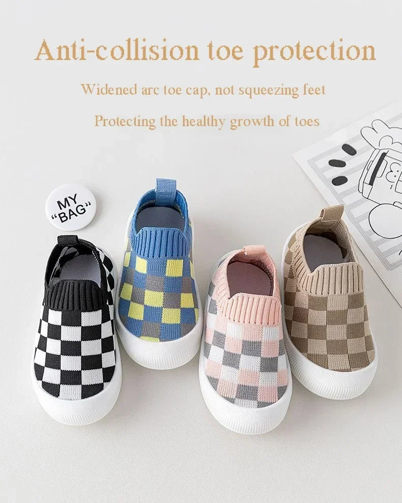 A collection of four knitted toddler shoes featuring various plaid patterns and toe protection designs.
