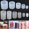 A collection of white geometric resin casting molds in various sizes and shapes for DIY jewelry and crafts.