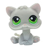 A cute gray cat bobble head figurine with large green eyes and pink accents.