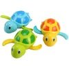 A set of colorful wind-up swimming turtle bath toys in blue, yellow, and green.