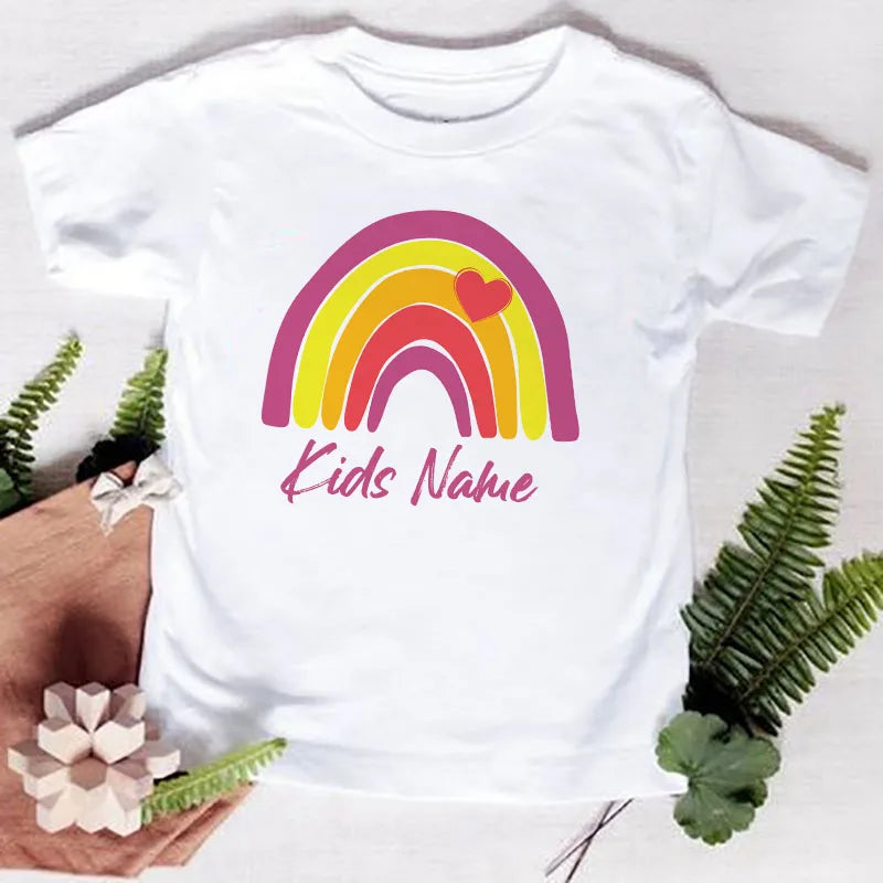 White t-shirt featuring a rainbow arch design in pink, yellow, and red, with the text Kids Name printed below.