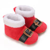 Pair of red baby winter boots with white faux fur trim and brown leather accents