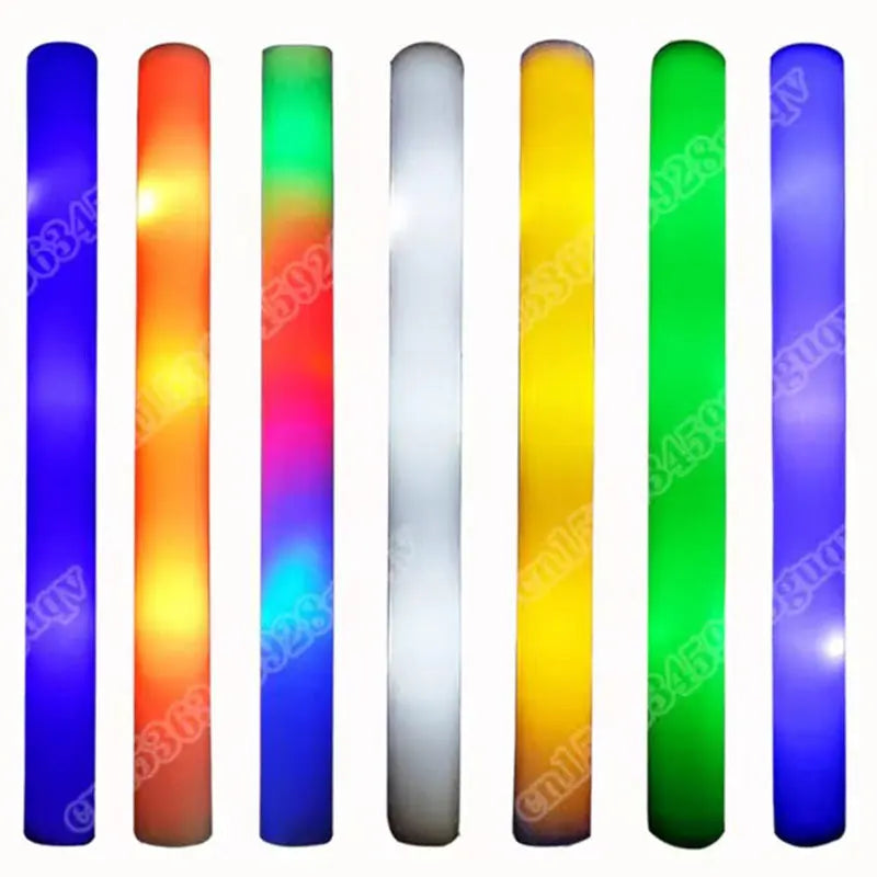 A row of ten giant foam LED glow sticks displaying various vibrant colors including blue, orange, green, and purple.