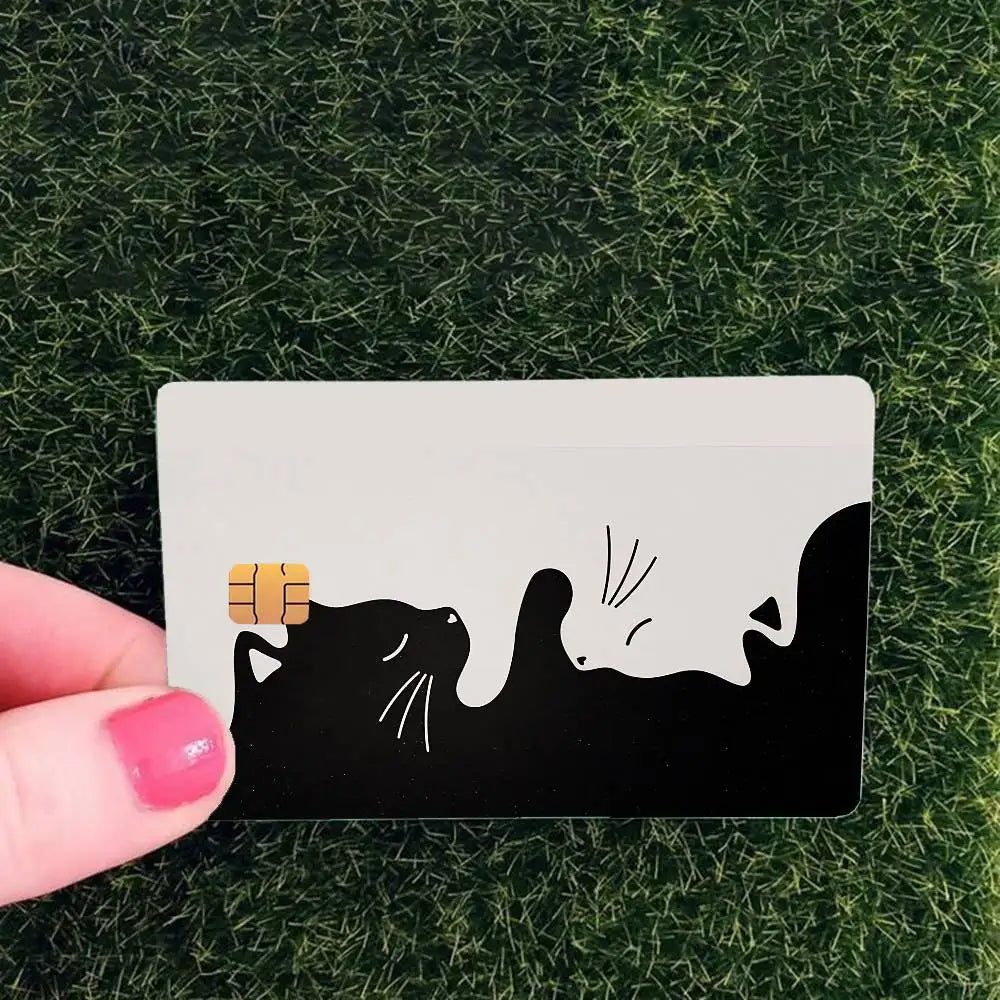 A black cat silhouette with whiskers and a paw print is printed on a white card against a green background.