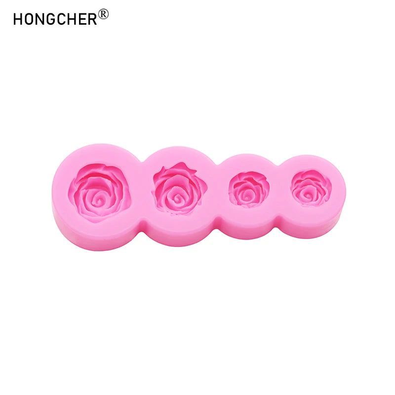A set of five pink silicone molds shaped like roses and peonies for resin, jewelry, and baking.